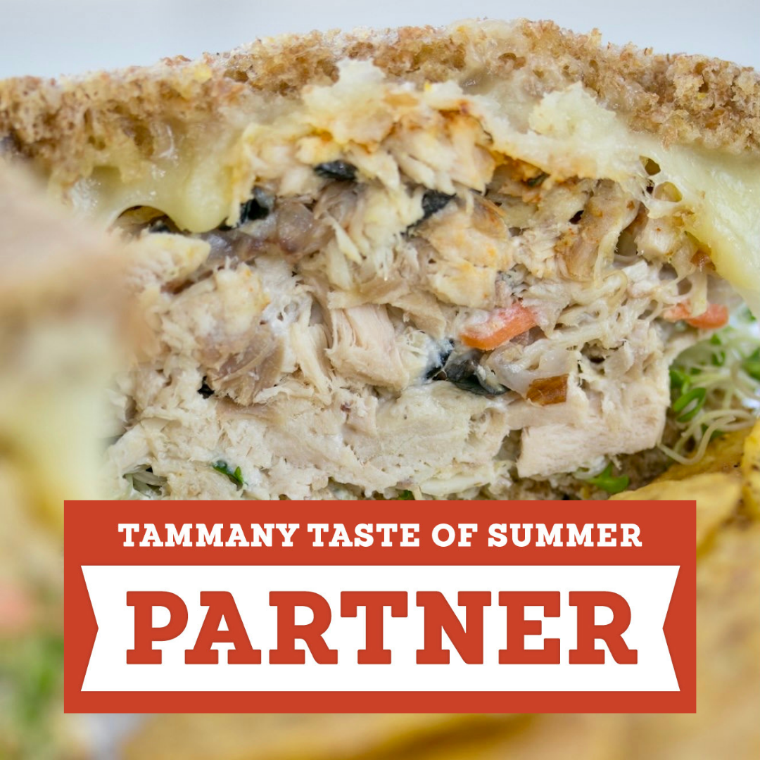 Tammany Taste of Summer partner badge over a chicken salad sandwich